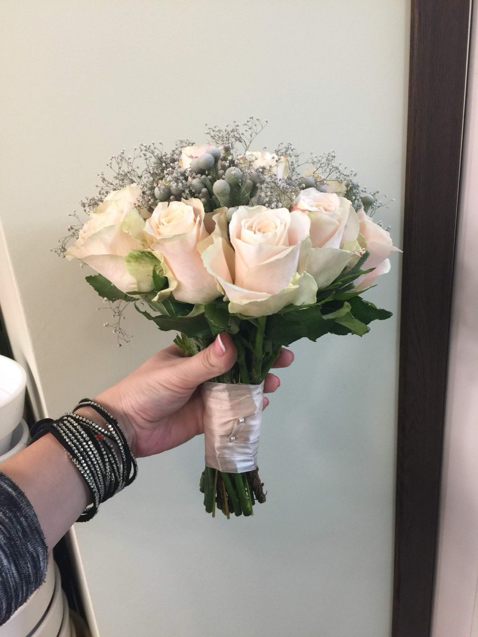 Bridal bouquet Timeless Elegance featuring soft peach roses, silver brunia berries, and delicate baby’s breath for a refined and romantic wedding arrangement