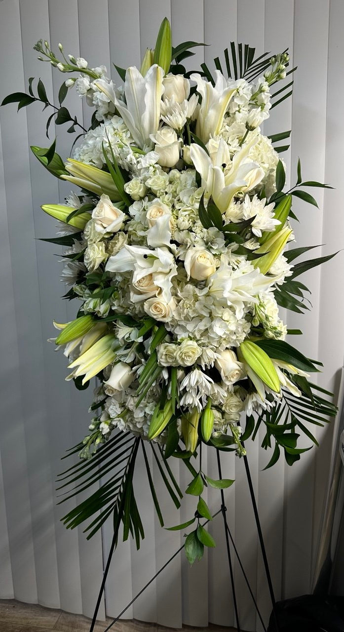 Memorial funeral tripod “Eternal Grace” with white lilies, roses, hydrangeas, and lush greenery — a tall sympathy flower arrangement to honor loved ones.