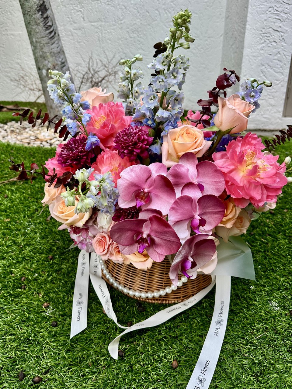 Bouquet of flowers in a basket on grass