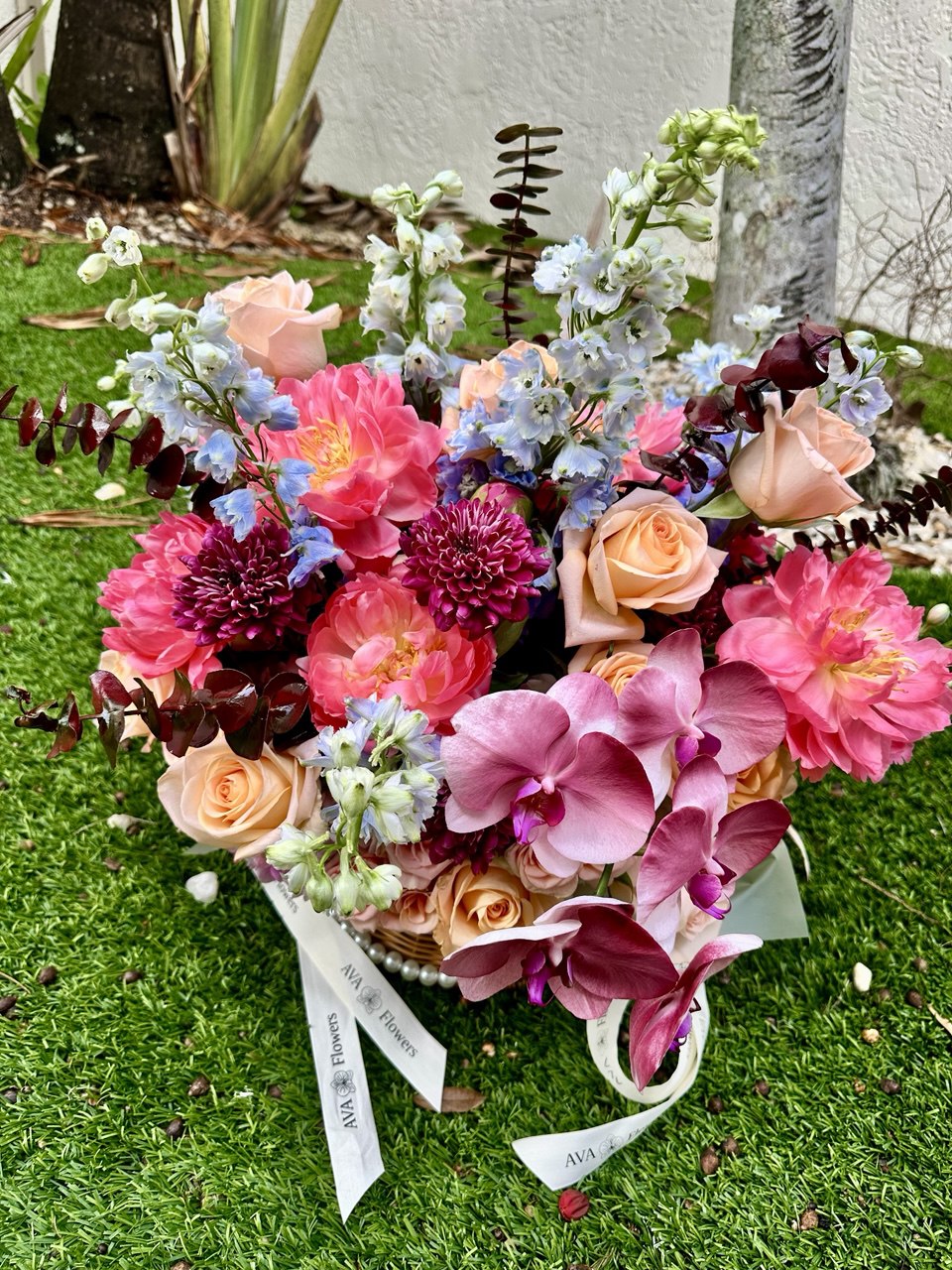 Colorful bouquet of flowers on a grassy surface with a blurred background