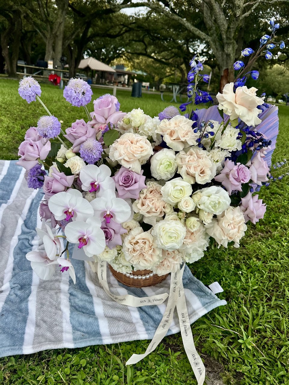 Bouquet of flowers on a striped blanket outdoors