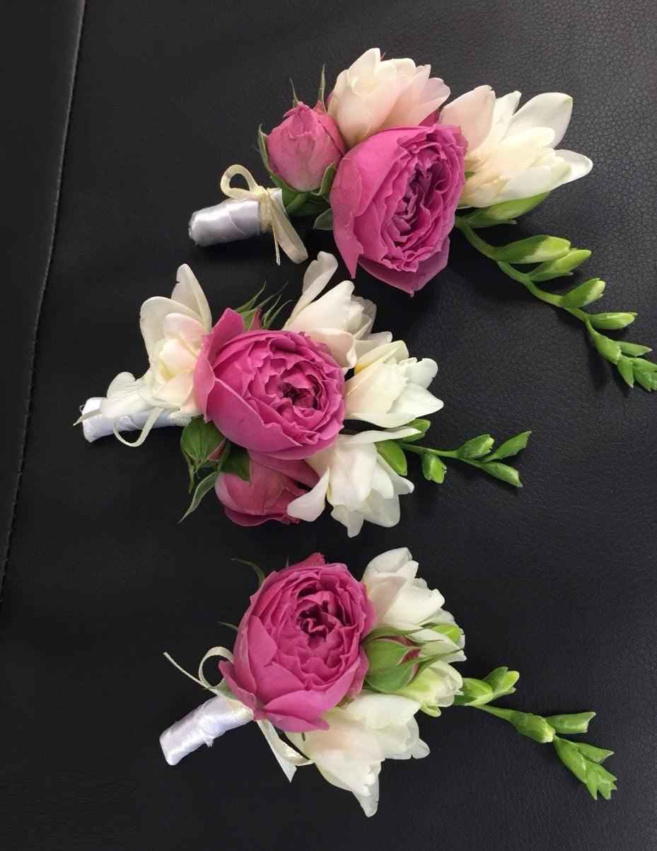 Charming wedding boutonniere handcrafted from fresh flowers, perfect for groom, groomsmen, or special guests.