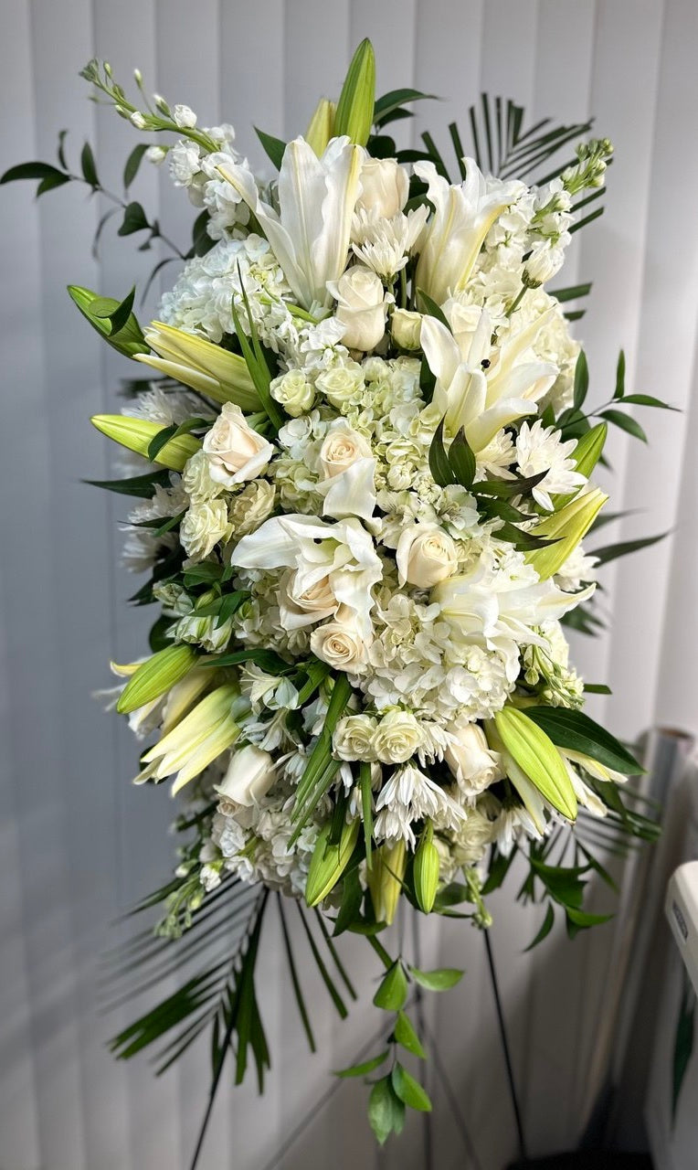 Memorial funeral tripod “Eternal Grace” with white lilies, roses, hydrangeas, and lush greenery — a tall sympathy flower arrangement to honor loved ones.