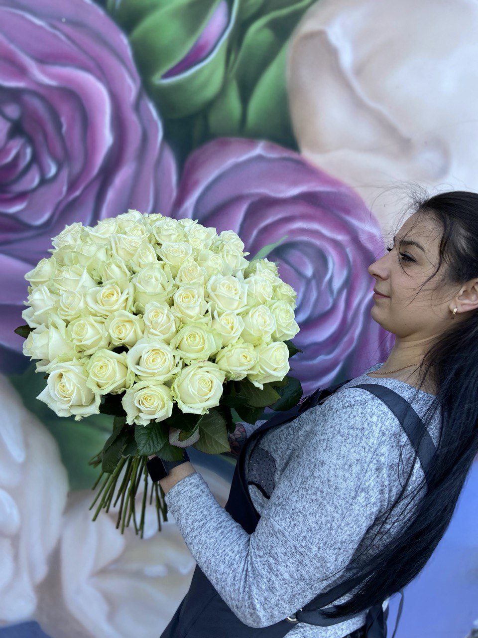 Elegant bouquet of 25 fresh white roses with lush green stems, symbolizing purity and sophistication — perfect for weddings, anniversaries, or special occasions