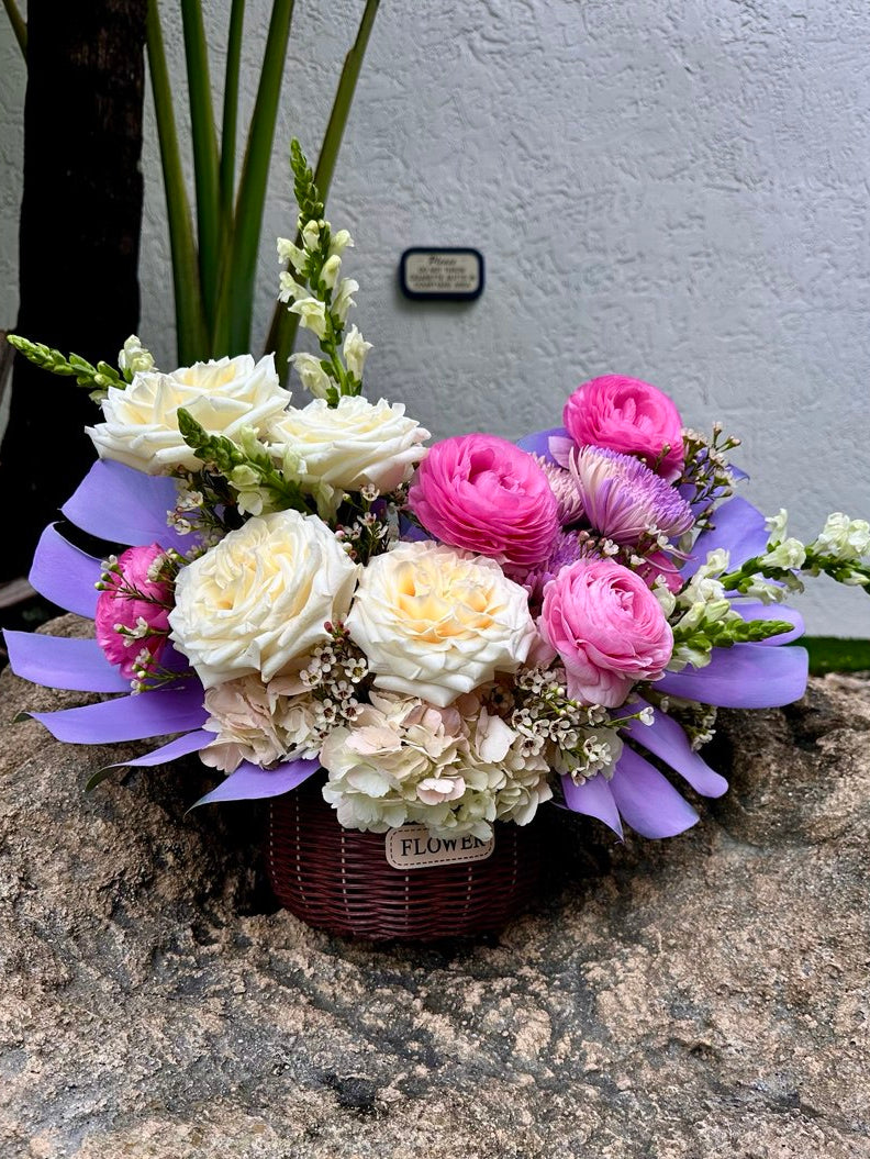 Bouquet of flowers with purple ribbons on a stone surface