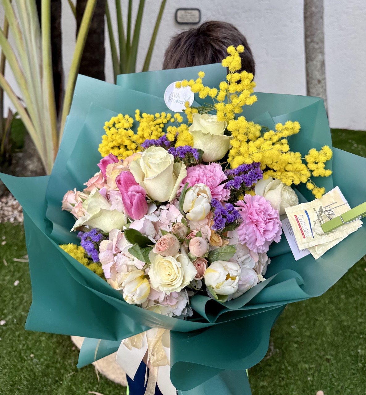 Bouquet of flowers with a child holding it outdoors