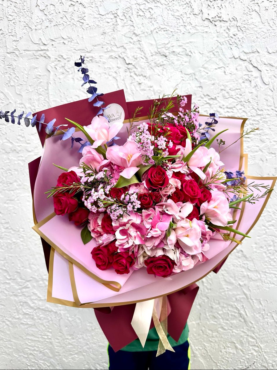 Bouquet of flowers with pink and red roses on a white background