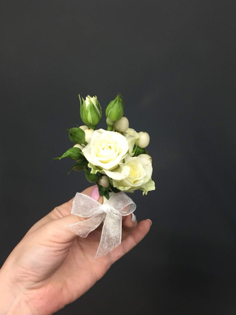 Charming wedding boutonniere handcrafted from fresh flowers, perfect for groom, groomsmen, or special guests.