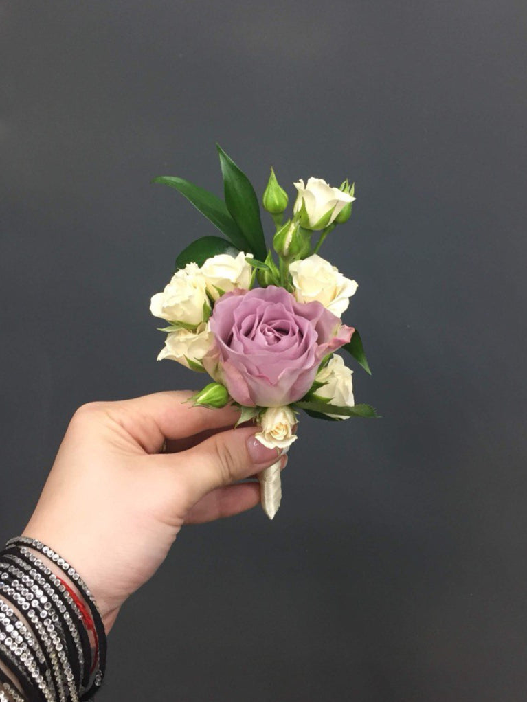Charming wedding boutonniere handcrafted from fresh flowers, perfect for groom, groomsmen, or special guests.