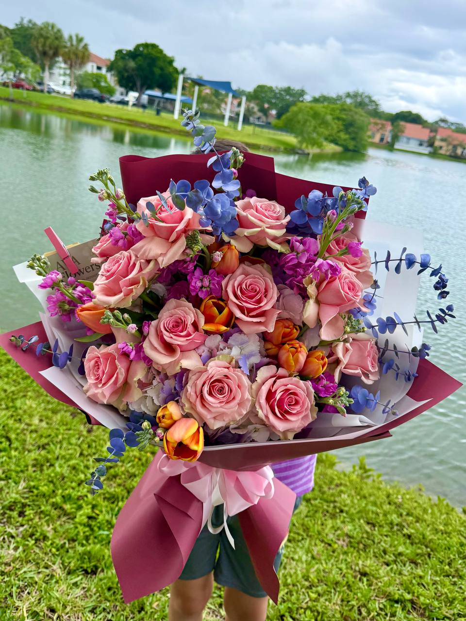 Luxury bouquet with pink roses, hydrangeas, tulips, and eucalyptus by the lake in Hollywood, Florida